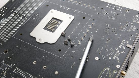 The back of a gaming motherboard with some screws removed