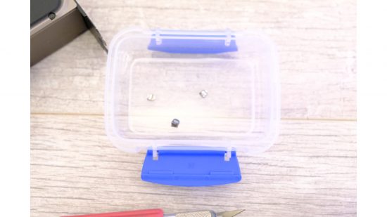 A plastic tub containing some screws