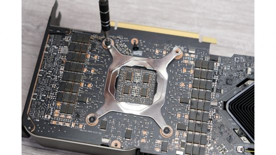 A screwdriver removing screws from the RTX 3080