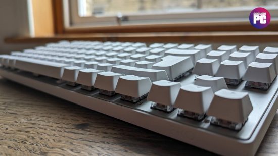 Logitech G Pro X TKL Lightspeed review: a white keyboard appears side-on on a wooden worktop.
