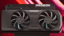 An AMD Radeon RX reference graphics card, featuring two fans, against a red-pink background